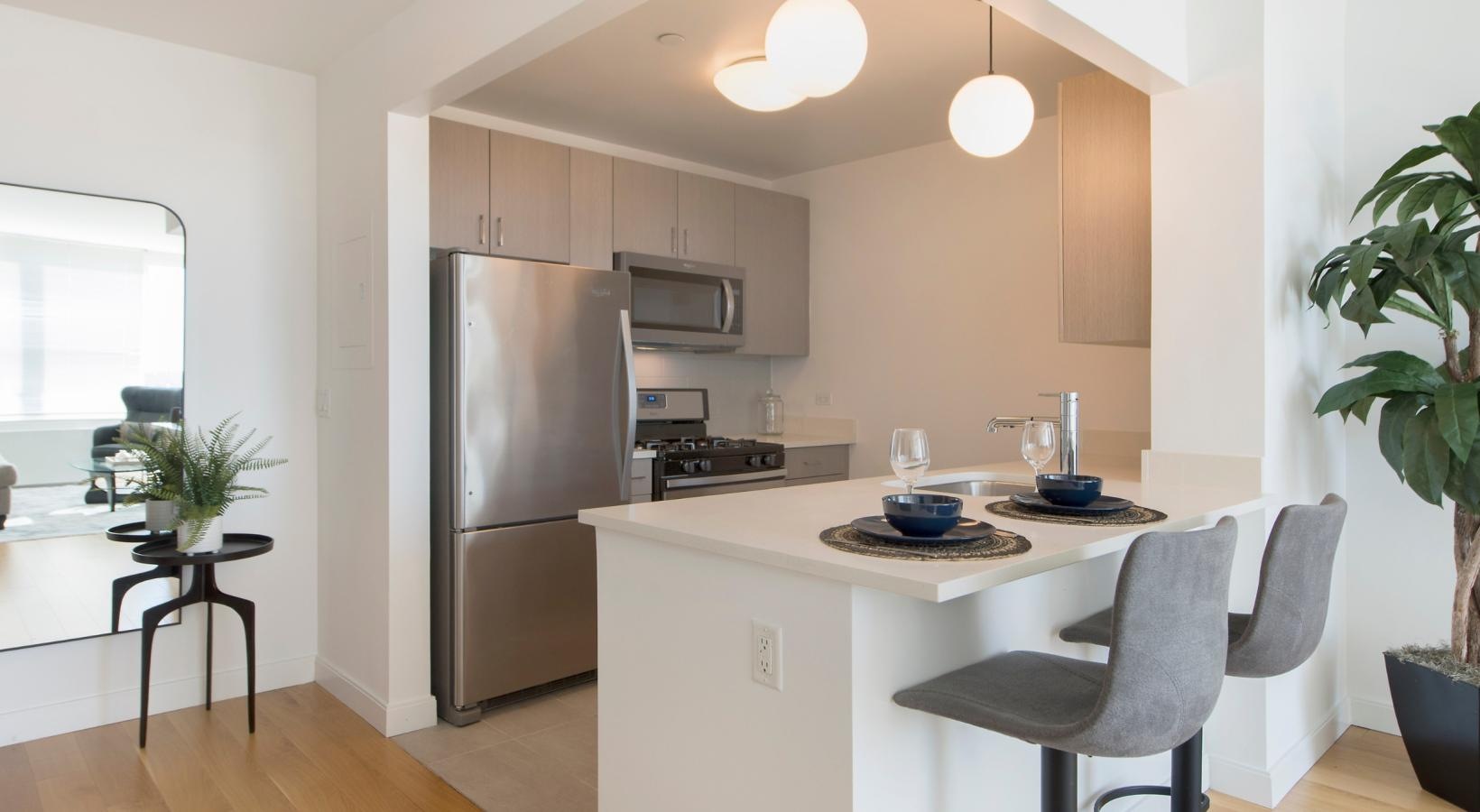 Spacious kitchens with thoughtful details a kitchen with a table and chairs